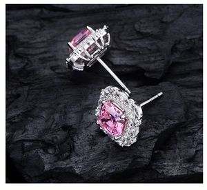 Macro view of halo earrings with pink Asscher cut stones and 925 silver studs