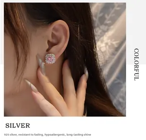 Close-up of pink square carbon diamond earring with 925 silver finish on model ear