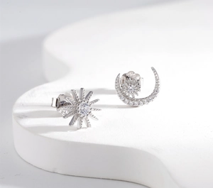 Macro shot of S925 sterling silver moon and sun earrings with hallmark detail