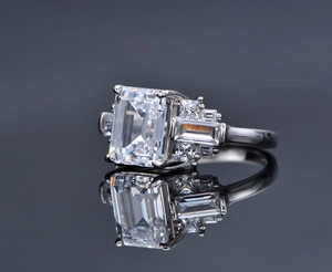 Macro shot of 8x10mm emerald cut stone on S925 silver ring with side trapezoid accents