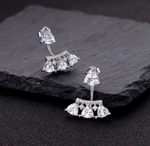 Macro view of S925 silver fan-shaped earrings with triangle-cut stones and drop design