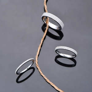 Sparkling 925 sterling silver three-row eternity ring with zircon stones on black reflection