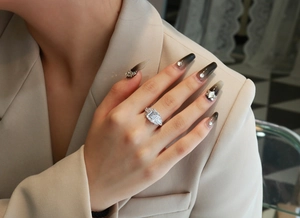 Elegant model shot of silver S925 ring with emerald-cut main stone on a manicured hand