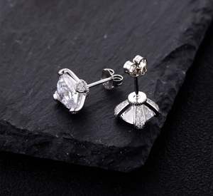 Macro side view of square princess cut stud earrings with 925 silver four-prong setting