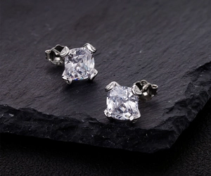 Macro shot of S925 sterling silver stamp and cushion-cut cubic zirconia stud earrings