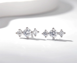 Macro shot of S925 sterling silver studs with three claw-set cubic zirconia stones