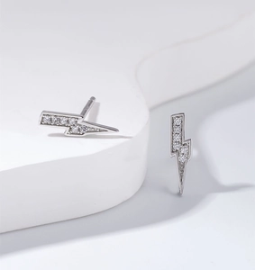 Macro shot of S925 sterling silver lightning earrings with sparkling zircon inlay