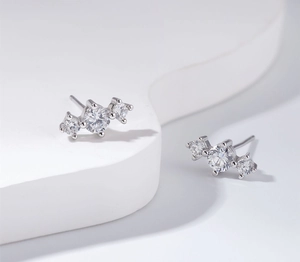 Close-up of S925 sterling silver stud earrings with 5A zircon in a three-stone setting