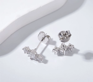Macro detail of S925 sterling silver stamp and sparkling zircon stones on earrings