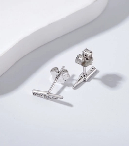 Macro detail of S925 sterling silver lightning bolt earrings with tiny zircon inlay