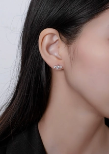 Close-up of minimalist S925 silver stud earrings with three sparkling 5A cubic zirconia