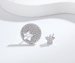 Macro view of asymmetrical S925 silver star earrings featuring micropave cubic zirconia