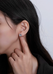 Close-up of elegant princess cut cubic zirconia stud earrings worn by a model