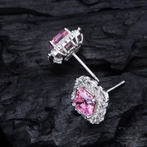 Pink halo earrings in 925 silver with Asscher cut carbon diamonds on a black wood base