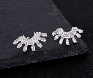 Detailed macro view of S925 sterling silver stamp and sparkling pave zircon fan earrings