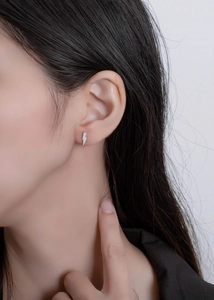 Macro shot of minimalist S925 sterling silver lightning bolt stud earrings with cubic zirconia