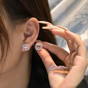 Luxurious pink asscher cut halo earrings in 925 sterling silver worn by a model