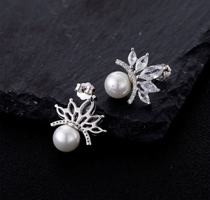 Detailed macro of S925 sterling silver crown earrings with white pearl and marquise zircon