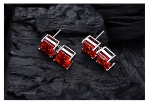 Macro view of S925 silver earrings featuring double stacked orange-red ice cut stones