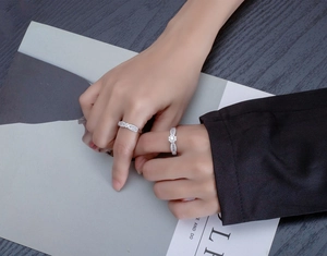 Macro detail of silver rings featuring micro-pave setting and six-prong main stone design
