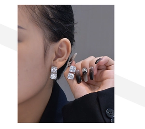 Detail of S925 silver stud earrings featuring double square ice flower cut carbon diamonds