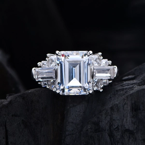 Emerald cut high carbon diamond S925 silver ring on a dark textured rock background