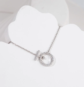 Detail of S925 sterling silver necklace featuring a sparkling CZ paved ring and T-bar pendant