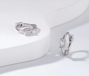 Detailed close-up of S925 sterling silver hoop earrings with rectangular cubic zirconia