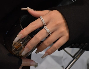 Close-up of stacked sterling silver snowflake rings with marquise-cut cubic zirconia