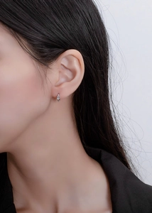 Detail view of a S925 sterling silver hoop earring with rectangular cubic zirconia