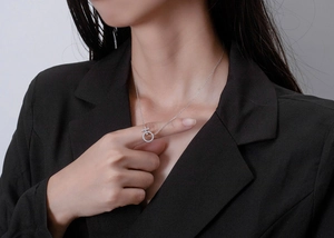 Detail of female symbol pendant in silver with crystal inlay on an O-link chain
