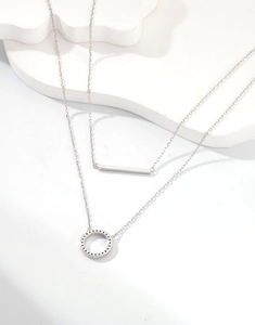 Close-up of double layer silver necklace showing S925 hallmark and crystal circle