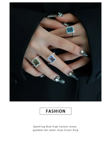 Macro detail of emerald-cut gemstone rings with side micro-pavé diamonds on model
