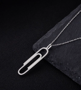 Macro view of sterling silver paperclip pendant with pavé micro-set cubic zirconia stones