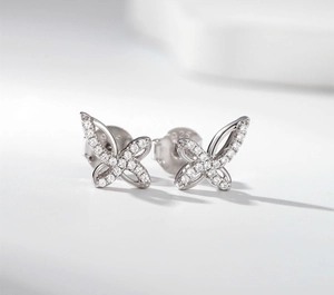 Macro shot of silver S925 bow earrings with sparkling micro-pave cubic zirconia