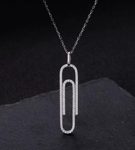 Macro shot of S925 sterling silver paperclip pendant necklace with micro-paved diamonds