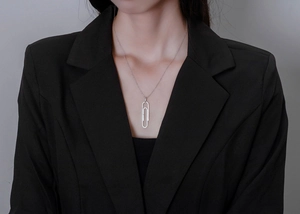 Close-up of S925 silver paperclip necklace with micro-pave diamonds on a model