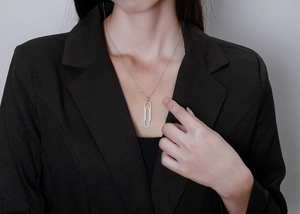 Detail of S925 silver paperclip necklace with micro-pave diamonds on a model