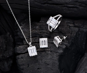 Macro shot of S925 silver jewelry set with rectangle cubic zirconia on dark background
