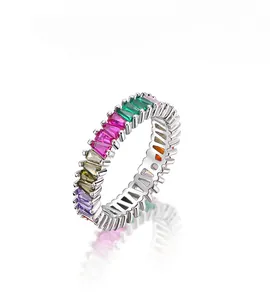 Macro detail of rainbow gradient baguette cut zircons on a silver eternity ring