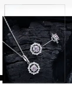 Macro view of pink floral cluster jewelry set with 925 silver and round cut gemstones