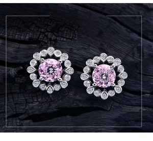 Macro view of 925 sterling silver floral stud earrings with pink gemstone and small diamonds