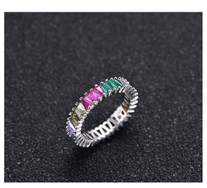 Macro shot of 925 silver eternity ring with colorful rainbow baguette cut crystals