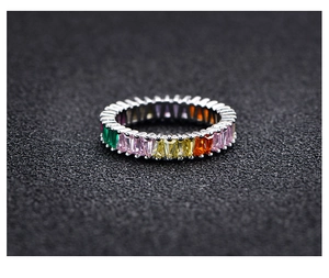 Detailed close-up of rainbow eternity ring with colorful rectangle-cut gemstones