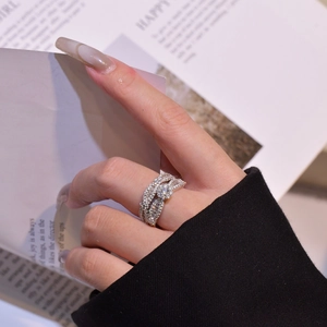Luxurious silver snowflake ring set with micro-pave crystals on model finger