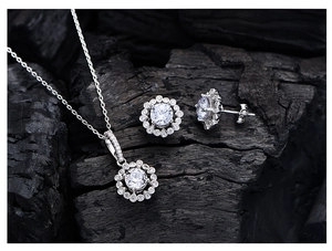 Macro shot of 925 silver halo jewelry set with round yellow stones on dark texture