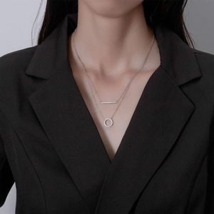 Double layer silver necklace with polished bar and shimmering crystal circle pendant