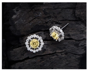 Macro shot of 925 sterling silver flower earrings with 6mm yellow high carbon diamond center