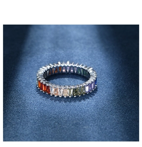 Macro shot of 925 silver eternity ring featuring rainbow gradient baguette cut crystals
