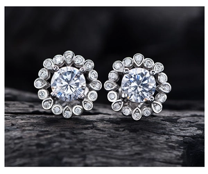 Macro shot of 925 silver sunflower stud earrings with a 6mm round cut yellow diamond center